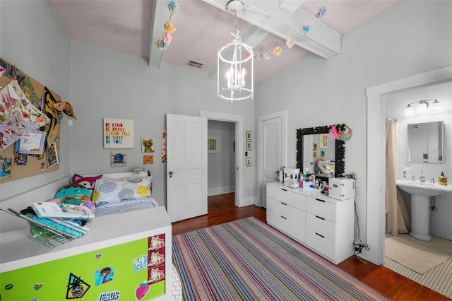 bedroom with an inviting chandelier, a sink, beam ceiling, and wood finished floors