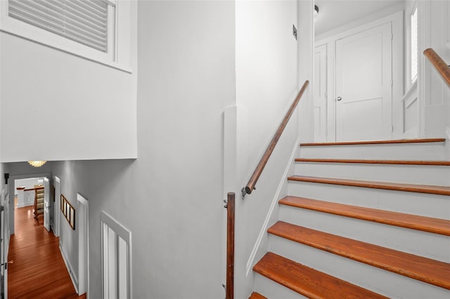 stairs featuring wood finished floors