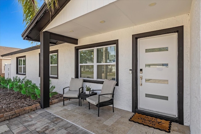 entrance to property featuring stucco siding