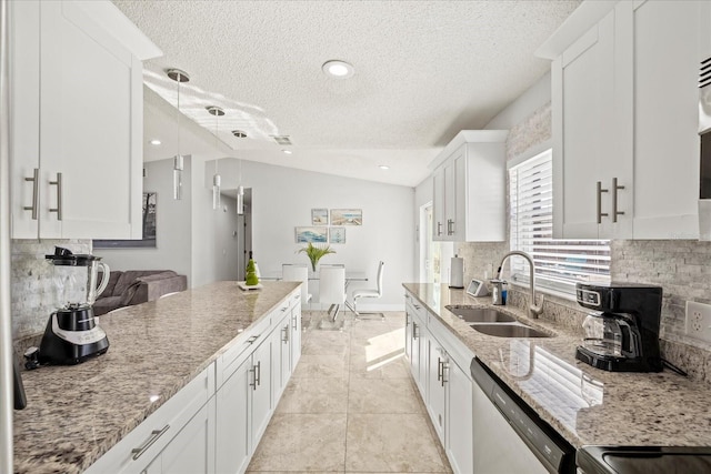 kitchen with a textured ceiling, decorative backsplash, a sink, and dishwasher