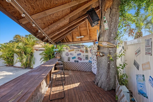 wooden deck with fence and outdoor dry bar