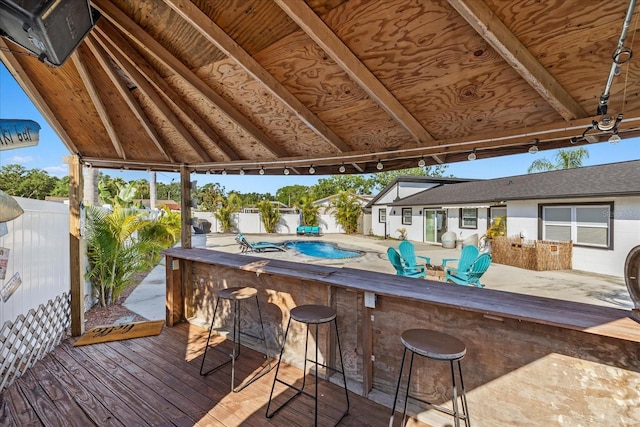 deck with fence and outdoor dry bar