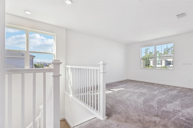 carpeted spare room with visible vents, recessed lighting, and baseboards