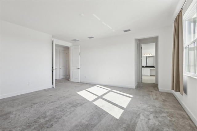 unfurnished bedroom with visible vents, carpet flooring, and baseboards