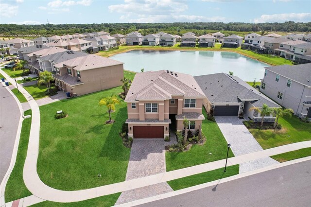 drone / aerial view featuring a water view and a residential view