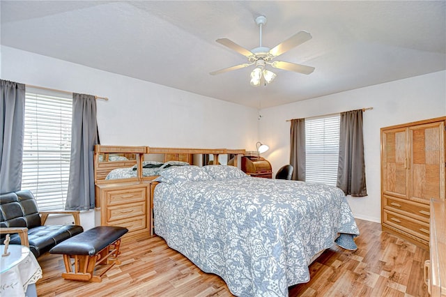 bedroom featuring a ceiling fan, baseboards, and light wood-style floors
