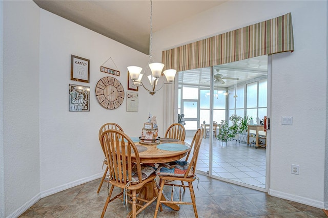tiled dining area with baseboards, a textured wall, and ceiling fan with notable chandelier