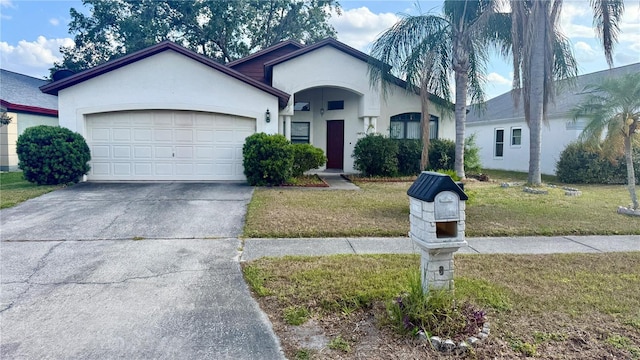 ranch-style house with an attached garage, stucco siding, concrete driveway, and a front yard