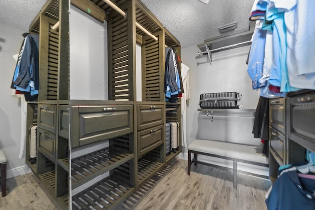 walk in closet featuring wood finished floors