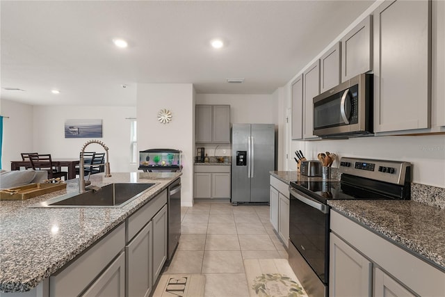 kitchen featuring recessed lighting, gray cabinetry, visible vents, a sink, and appliances with stainless steel finishes