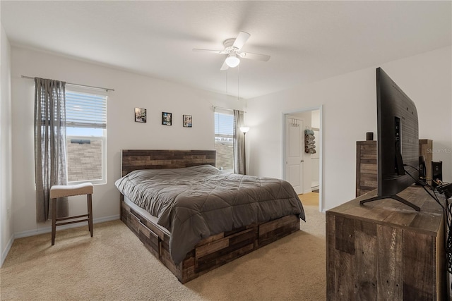 bedroom with light colored carpet, baseboards, and a ceiling fan