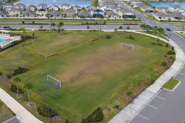 drone / aerial view with a water view and a residential view