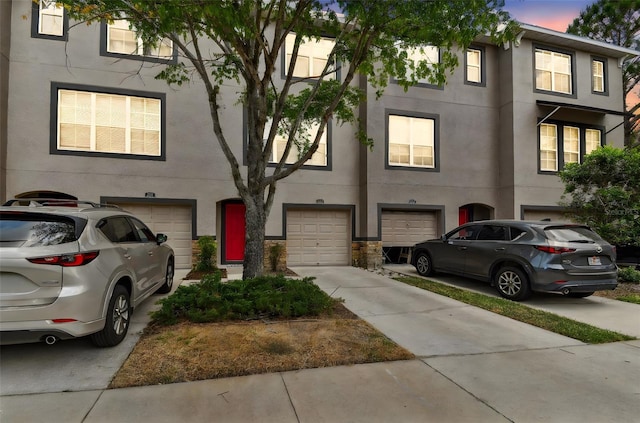 2547 Lexington Oak Dr, Brandon, FL 33511 - view of property with a garage, driveway, and stucco siding