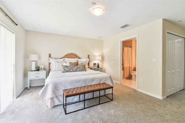 2547 Lexington Oak Dr, Brandon, FL 33511 - carpeted bedroom with baseboards, ensuite bathroom, a textured ceiling, and a closet