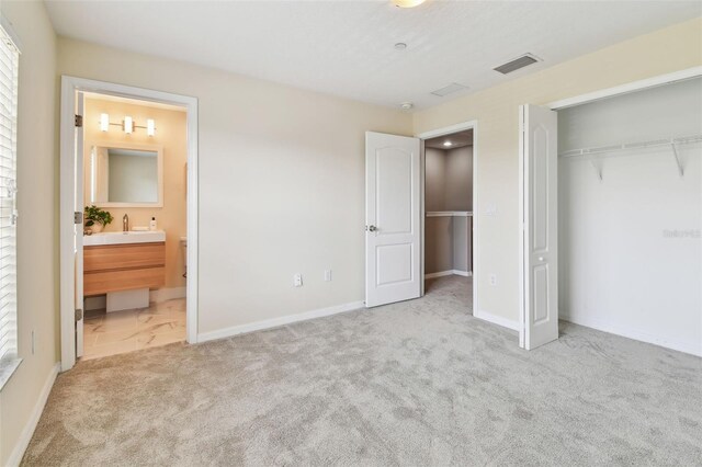 2547 Lexington Oak Dr, Brandon, FL 33511 - unfurnished bedroom featuring carpet floors, a closet, a sink, ensuite bath, and baseboards
