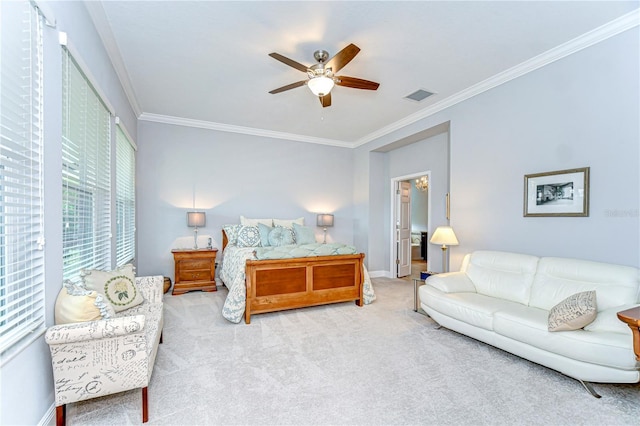 carpeted bedroom featuring visible vents, ornamental molding, baseboards, and a ceiling fan