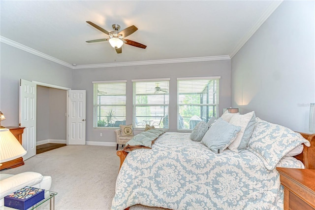 bedroom featuring crown molding, baseboards, ceiling fan, and carpet floors