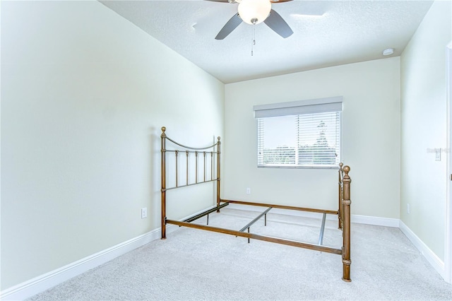 unfurnished bedroom featuring baseboards, carpet flooring, and a textured ceiling
