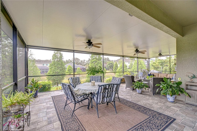 sunroom / solarium with ceiling fan, outdoor dining area, and an outdoor hangout area