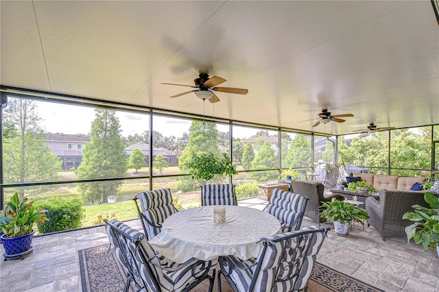 sunroom / solarium featuring an outdoor living space and a ceiling fan