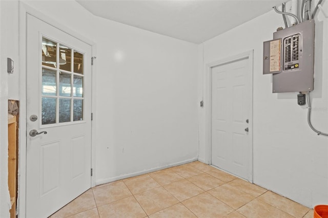 doorway to outside featuring electric panel and light tile patterned flooring