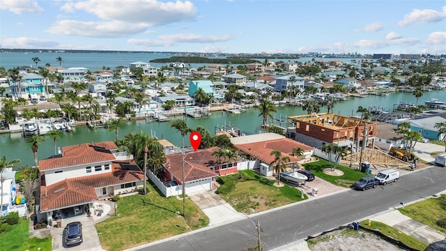 drone / aerial view with a residential view and a water view