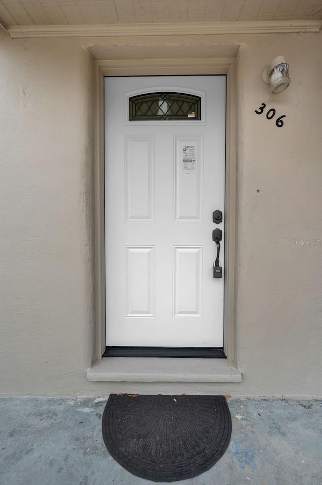 entrance to property with stucco siding