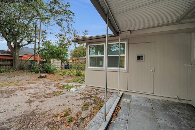 entrance to property featuring fence