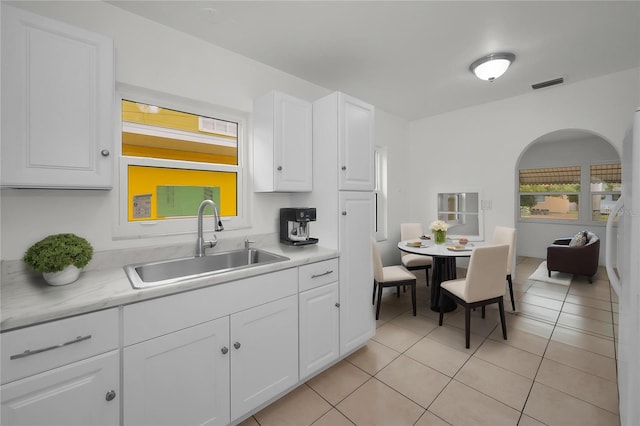 306 S Highland Ave, Clearwater, FL 33755 - kitchen with a sink, light countertops, white cabinetry, and light tile patterned flooring
