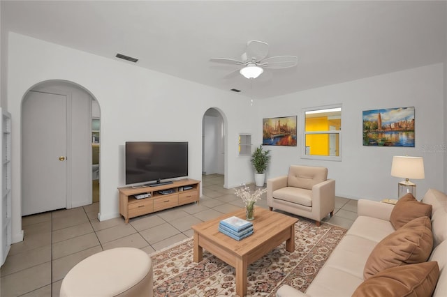 306 S Highland Ave, Clearwater, FL 33755 - living area with arched walkways, ceiling fan, and light tile patterned flooring