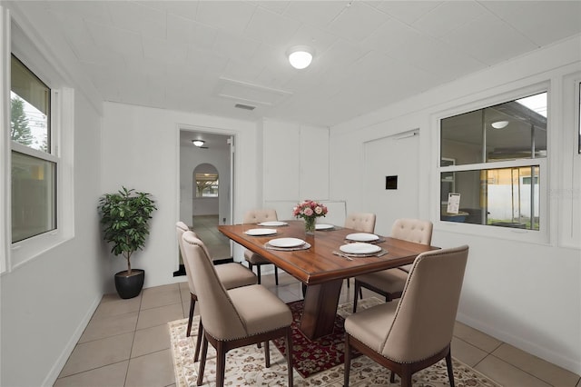 306 S Highland Ave, Clearwater, FL 33755 - dining room featuring light tile patterned floors, healthy amount of natural light, and baseboards