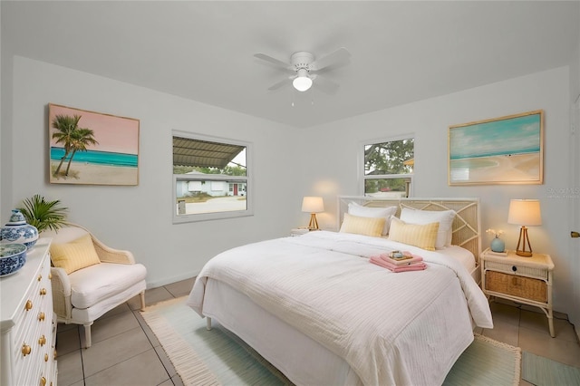 306 S Highland Ave, Clearwater, FL 33755 - bedroom with light tile patterned floors, multiple windows, a ceiling fan, and baseboards