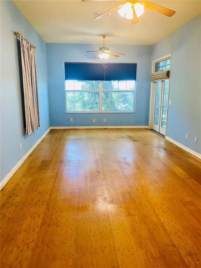 208 Shepard Ave, Dundee, FL 33838 - unfurnished room featuring healthy amount of natural light, a ceiling fan, wood finished floors, and baseboards