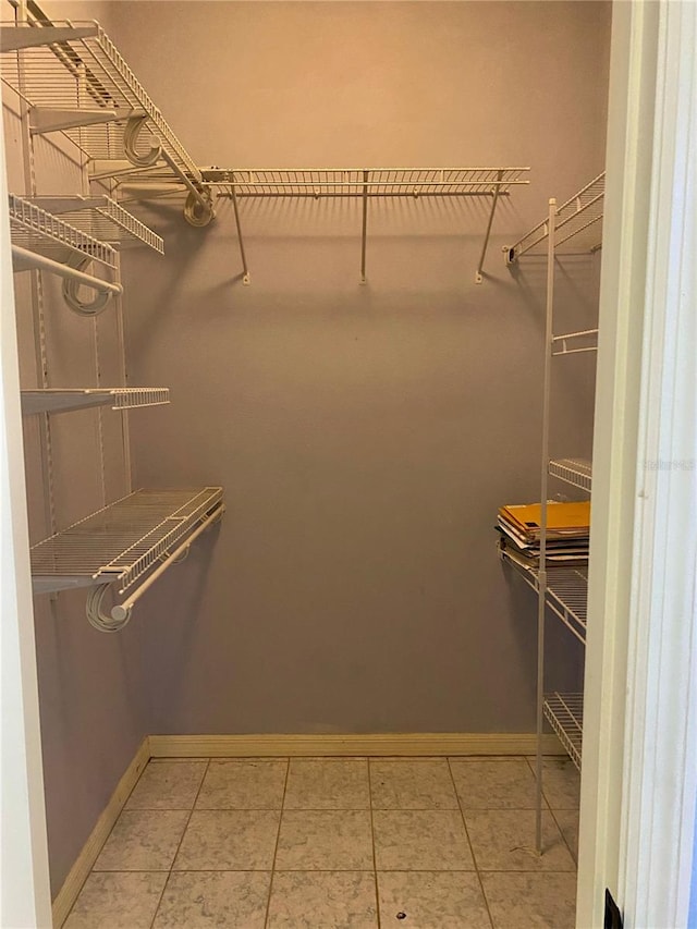 208 Shepard Ave, Dundee, FL 33838 - walk in closet featuring light tile patterned floors