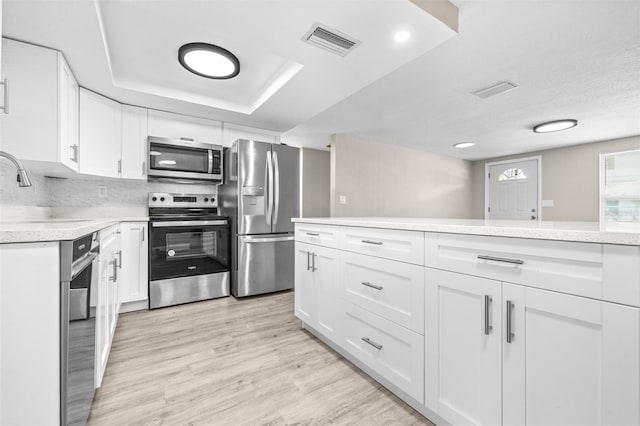 13926 Helen Ave, Hudson, FL 34667 - kitchen featuring visible vents, a sink, appliances with stainless steel finishes, and light countertops
