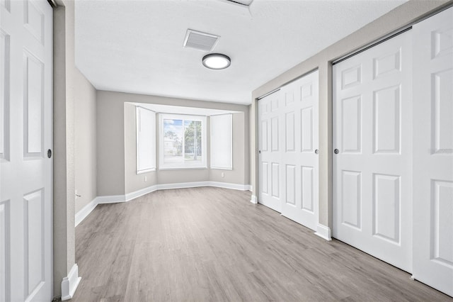 13926 Helen Ave, Hudson, FL 34667 - unfurnished bedroom featuring baseboards, a closet, wood finished floors, and visible vents