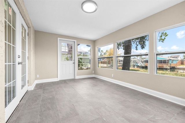 13926 Helen Ave, Hudson, FL 34667 - unfurnished sunroom with baseboards and french doors