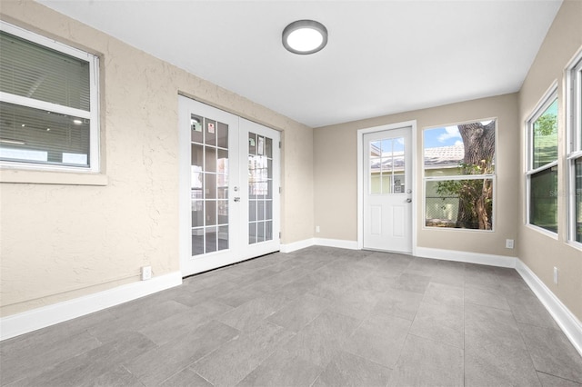 13926 Helen Ave, Hudson, FL 34667 - empty room featuring baseboards, tile patterned flooring, and french doors