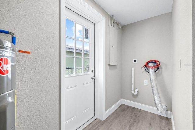 13926 Helen Ave, Hudson, FL 34667 - laundry room with hookup for an electric dryer, laundry area, light wood-type flooring, baseboards, and a textured wall