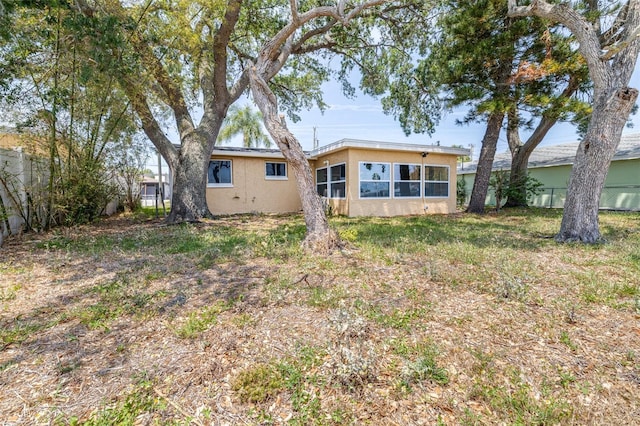 13926 Helen Ave, Hudson, FL 34667 - rear view of property with fence and stucco siding