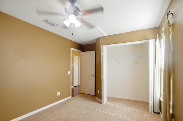 unfurnished bedroom with visible vents, carpet, baseboards, and a closet