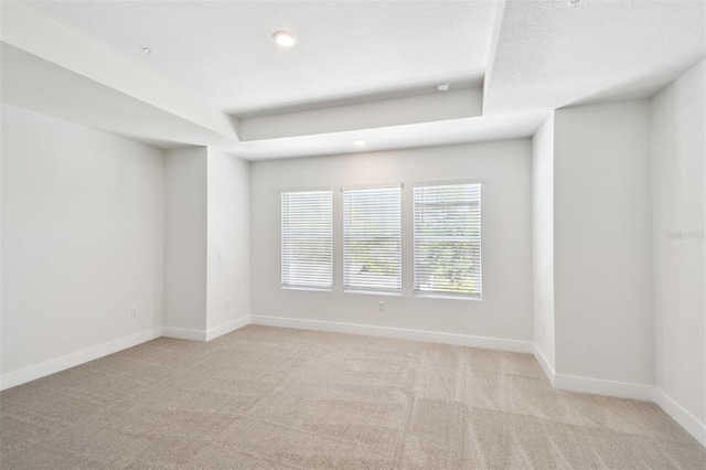 2123 1st Ave N, Saint Petersburg, FL 33713 - carpeted spare room featuring baseboards, a tray ceiling, and recessed lighting