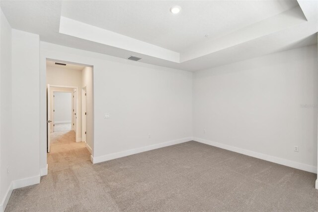 2123 1st Ave N, Saint Petersburg, FL 33713 - spare room featuring a raised ceiling, light colored carpet, baseboards, and recessed lighting