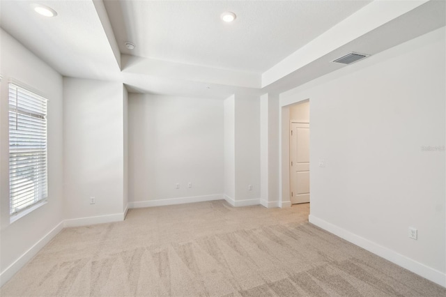 2123 1st Ave N, Saint Petersburg, FL 33713 - empty room featuring a tray ceiling, light colored carpet, recessed lighting, and baseboards