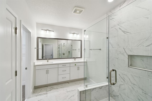 2123 1st Ave N, Saint Petersburg, FL 33713 - bathroom with a marble finish shower, double vanity, and marble finish floors