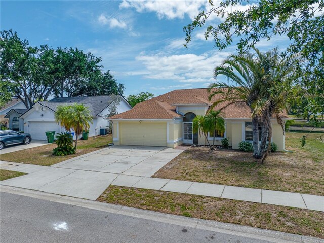 709 47th St E, Bradenton, FL 34208 - view of front of property featuring stucco siding, driveway, a front yard, and a garage