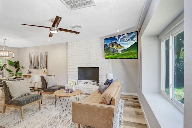 living area featuring a healthy amount of sunlight, light wood-type flooring, and visible vents
