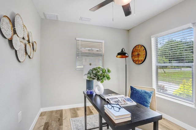 office area with baseboards, light wood finished floors, and ceiling fan