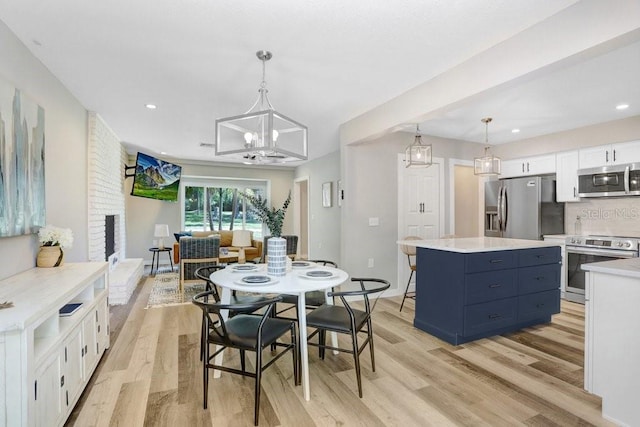 dining area featuring recessed lighting, a chandelier, and light wood-style flooring