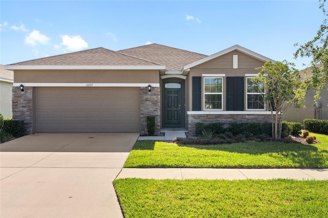 13227 Waterleaf Garden Cir, Riverview, FL 33579 - view of front of home featuring a garage, stucco siding, driveway, and a front yard